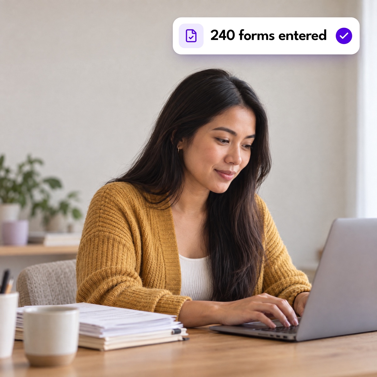 An assistant typing beside a stack of paper forms, with a "240 forms entered" notification
