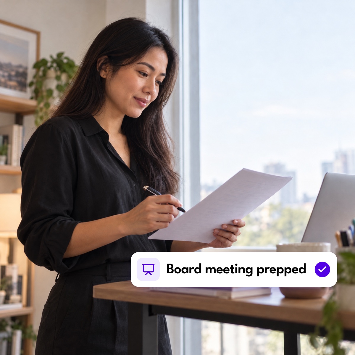 An executive assistant reading a document by an office window, with a "Board meeting prepped" notification